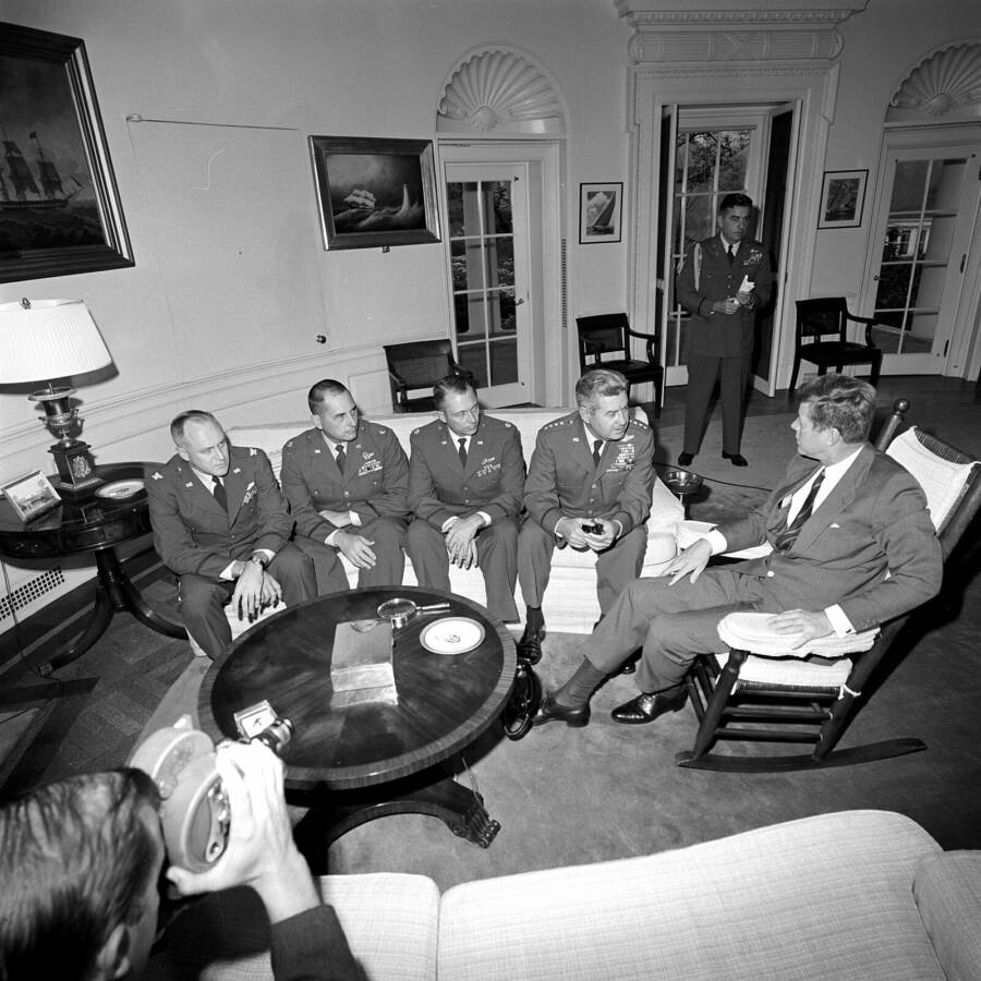 President John F. Kennedy (at right, in rocking chair) meets with United States Air Force (USAF) officers who took part in aerial photo-reco