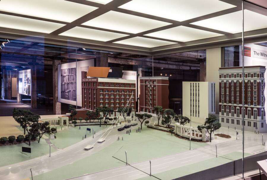 Title: Exhibit showing a mock-up of Dealey Plaza and the Texas School Book Depository, inside the sixth-floor storeroom of the building in